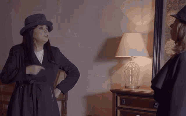 a woman in a hat stands next to another woman