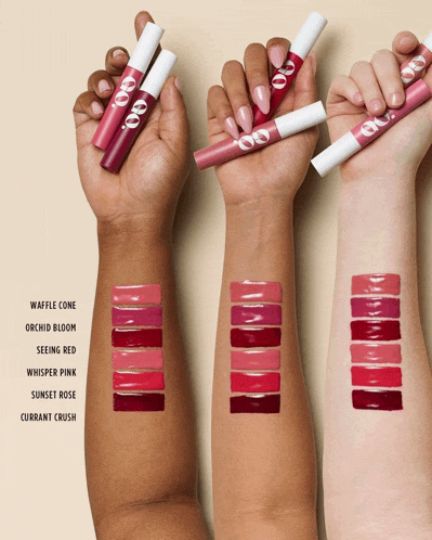 a woman 's arm is shown with different shades of lipstick