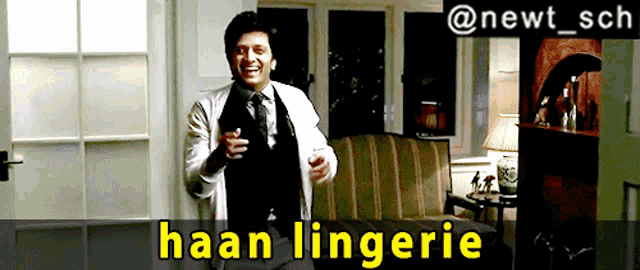 a man in a white coat and tie is dancing in a living room with the caption haan lingerie