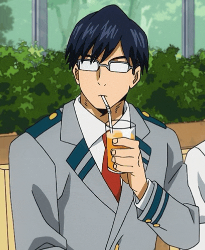 a man in a suit and tie drinking through a straw