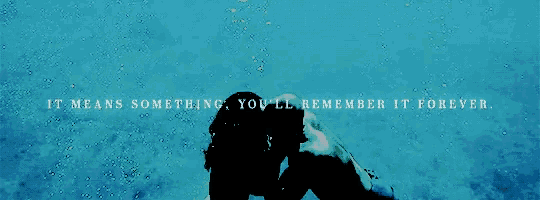 a couple kissing underwater with the words " it means something you 'll remember it forever " above them