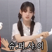a girl with pigtails is holding a remote control in her hand in a foreign language .