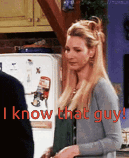 a woman is standing in front of a refrigerator with the words " i know that guy " on it