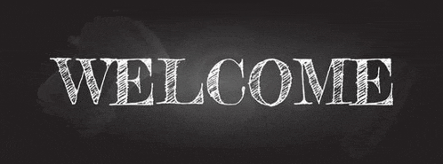 the word welcome is written on a blackboard in white chalk .