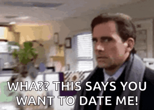 a man in a suit and tie is standing in an office and talking to another man .