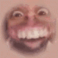a close up of a person 's face with a smile on it .