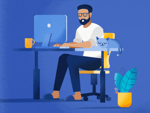 a man is sitting at a desk with a cat on his lap