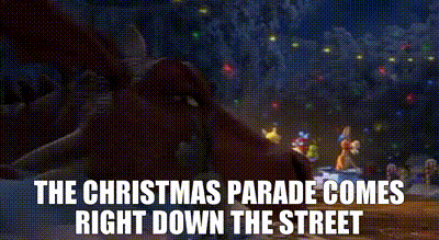 a christmas parade is coming right down the street in a cartoon .