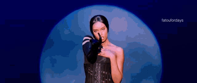 a woman with a mask on her face is standing in front of a full moon ..
