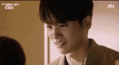 a close up of a person 's face with a jtbc logo in the background