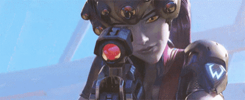 a woman is holding a gun in front of her face and looking through it .