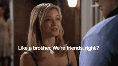 a woman is talking to a man who is smoking a cigarette and asking if they are friends .