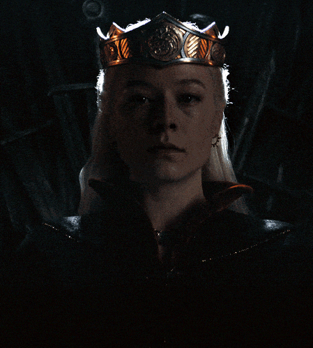 a woman with a crown on her head looks serious