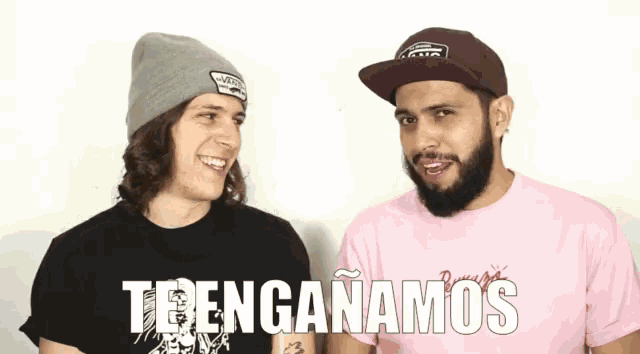 two men are standing next to each other and one of them is wearing a pink shirt that says trenganamos