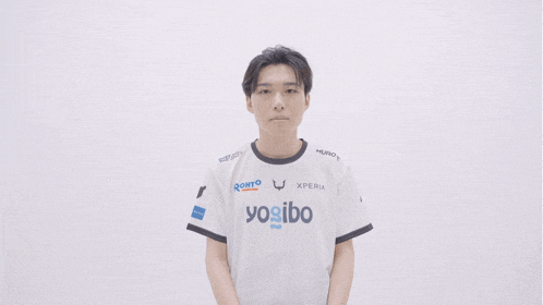 a young man wearing a white shirt that says yogibo