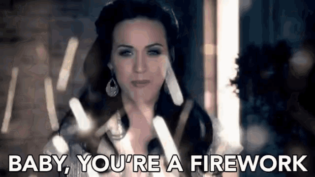 a woman is saying `` baby , you 're a firework '' in front of a window .