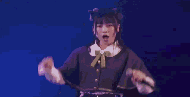 a girl is singing into a microphone on stage .