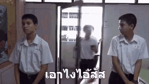 a group of young men are standing next to each other in front of a door .