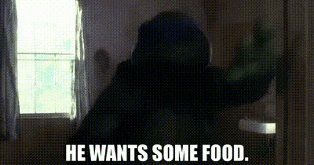 a person is standing in front of a window with the words `` he wants some food . ''