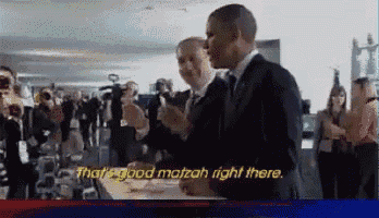 a man in a suit says that 's good matzah right there in front of a crowd