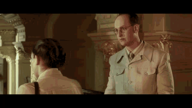 a man and a woman are standing next to each other in a room