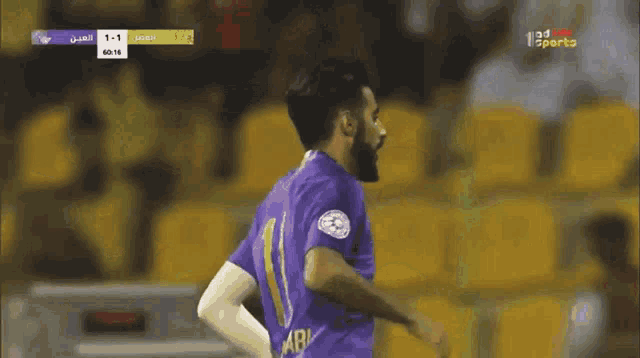 a soccer player wearing a purple jersey with the number 11 on it