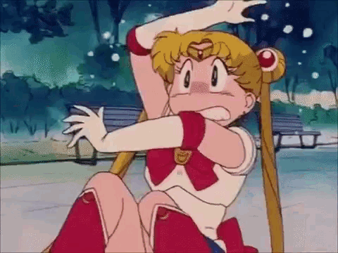 sailor moon is sitting on the ground in a park holding a pole .