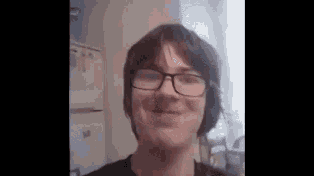 a close up of a person wearing glasses and headphones .