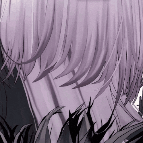 a close up of a person 's hair with a few leaves in the background