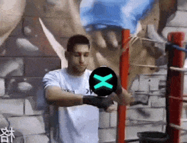 a man in a white shirt is holding a green x in his hand