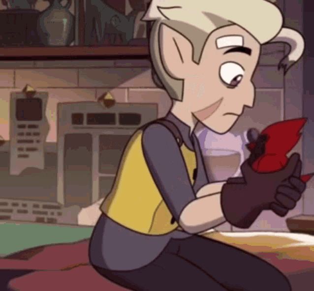 a cartoon character is sitting on a bed holding a red object in his hands .