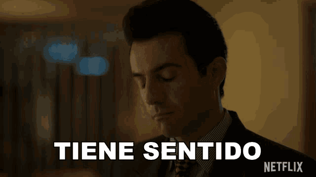 a man in a suit and tie says tiene sentido in white letters