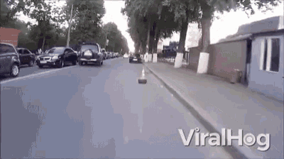 a video of cars driving down a street with the words viralhog on the bottom right