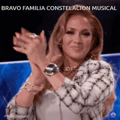 a woman is applauding with the words bravo familia constelacion musical behind her