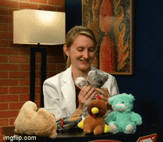 a woman in a lab coat holds a stuffed animal in her hands