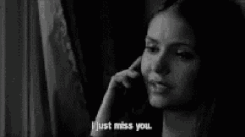 a woman is talking on a cell phone and says i just miss you .