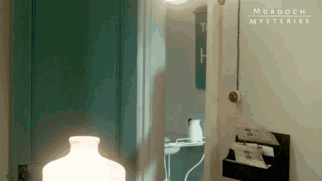 a poster for murdoch mysteries shows a bathroom with a sink and a lamp