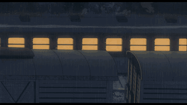 a train is going down the tracks in the rain and the lights are on