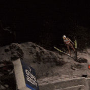 a person is jumping in the air with skis on