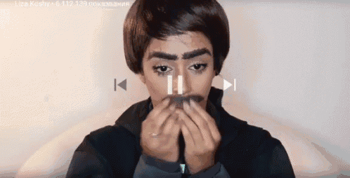 a man with a fake mustache is playing a video on a computer screen