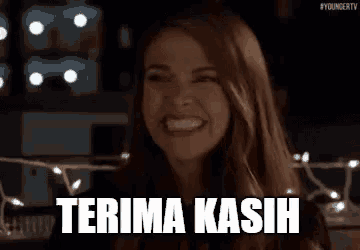 a woman is smiling and giving a thumbs up with the words terima kasih .