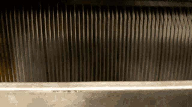 a close up of a metal wall with a few lines