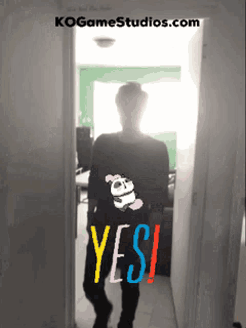 a man is standing in a doorway with a panda on his shirt and the words yes written on his back