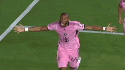 a group of soccer players wearing pink jerseys with the number 16 on them