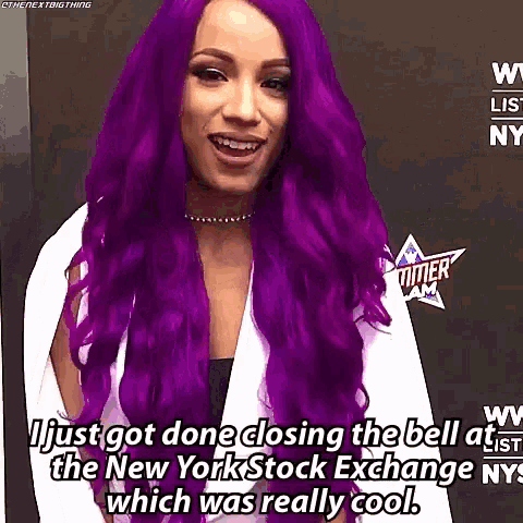 a woman with purple hair is smiling while talking about closing the bell at the new york stock exchange which was really cool .