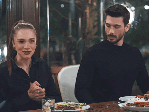 a man and a woman are sitting at a table with plates of food and the words minimalmoons on the bottom