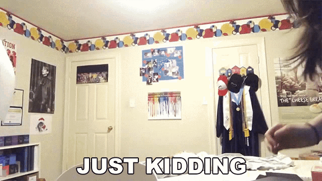 a girl in a room with a sign that says just kidding