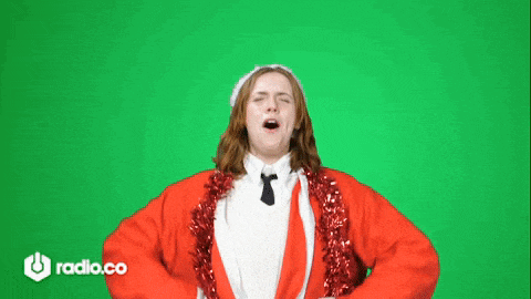 a woman in a santa suit is dancing on a green screen .
