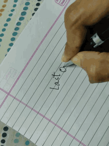a person 's hand is writing the word lost on a piece of paper