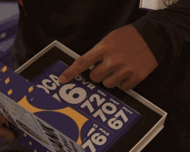 a person is pointing at a book that says over dri def phy